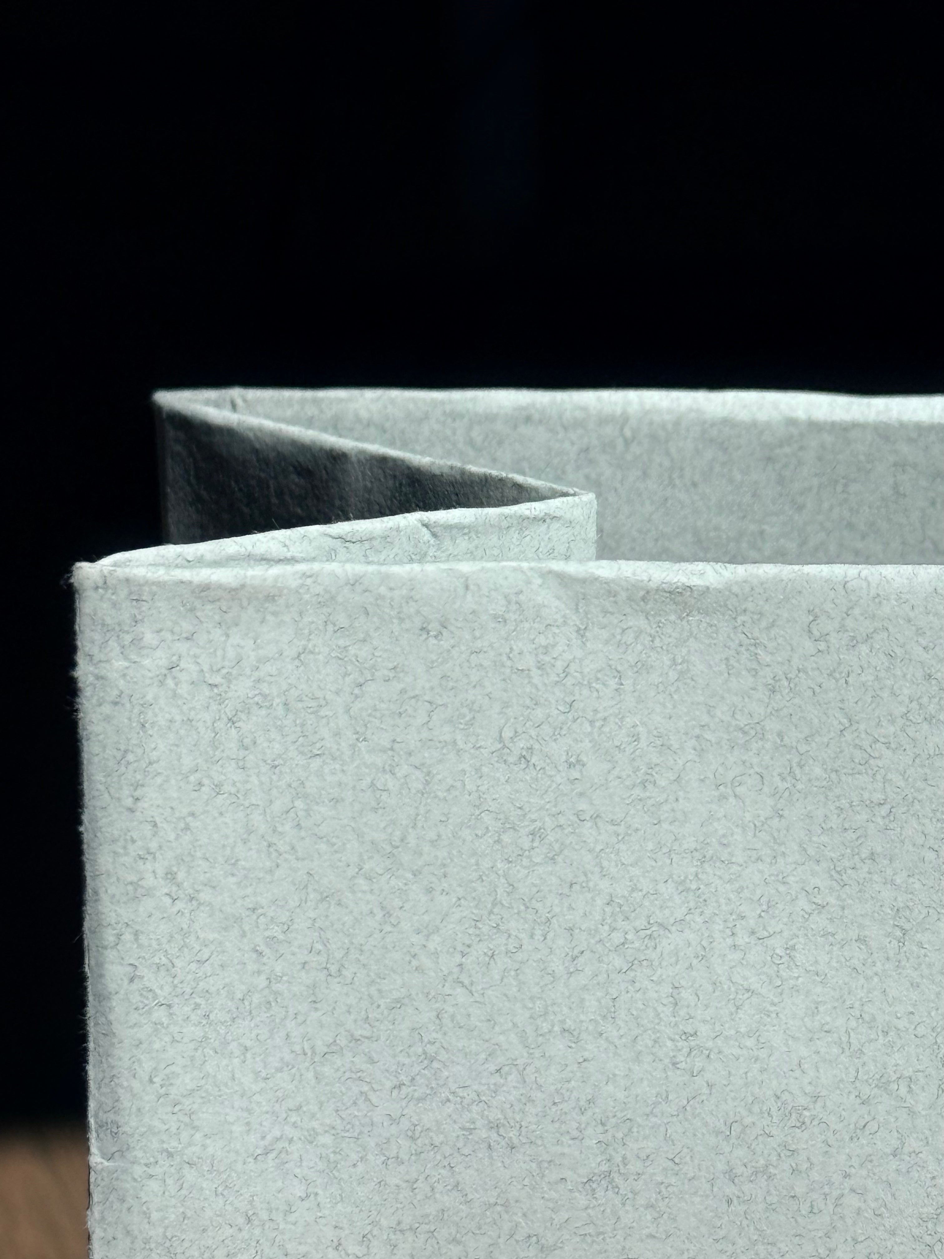 Close-up of textured gray panels on a black background